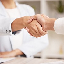 Two women shaking hands