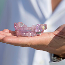 Person holding oral appliance