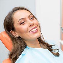 Lady laying in dental chair smiling