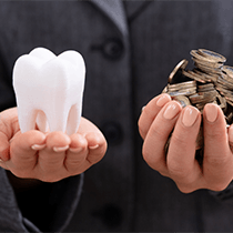 Tooth and coin balance in opened hands