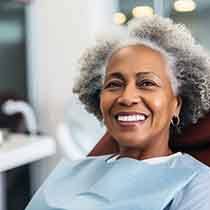 a patient smiling after receiving dental implant salvage treatment